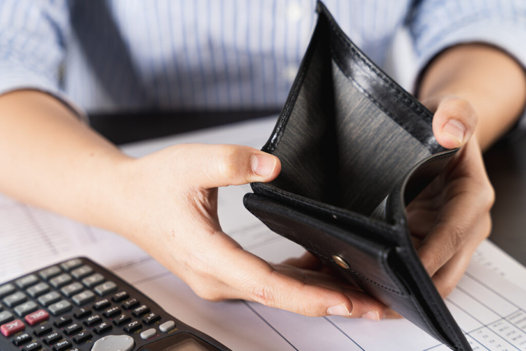 woman holding open empty wallet looking for money having problem bankrupt broke after credit card payday. Insolvency in the economy and finance. People have no money.